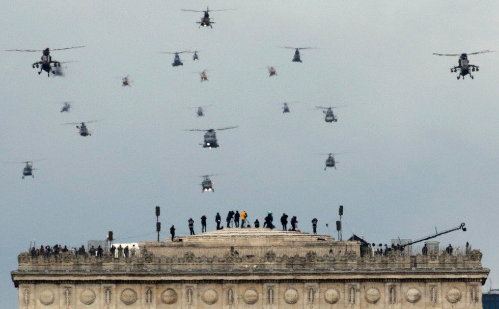 A formation of military helicopters fly over the Arc de Triumph during the traditional Bastille Day military parade in Paris, France. Mal Langsdon is a Reuters staffer based in Paris, France.