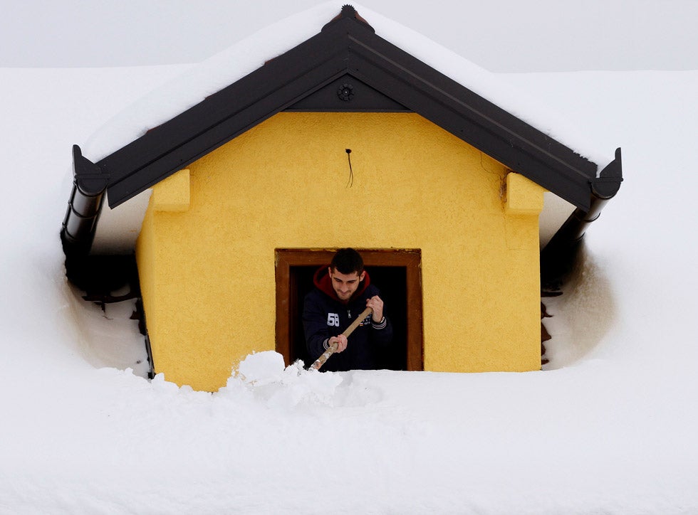 An Albanian boy cleans snow from his window near the city of Kukes. Arben Celi is an Albian photographer shooting for Reuters.