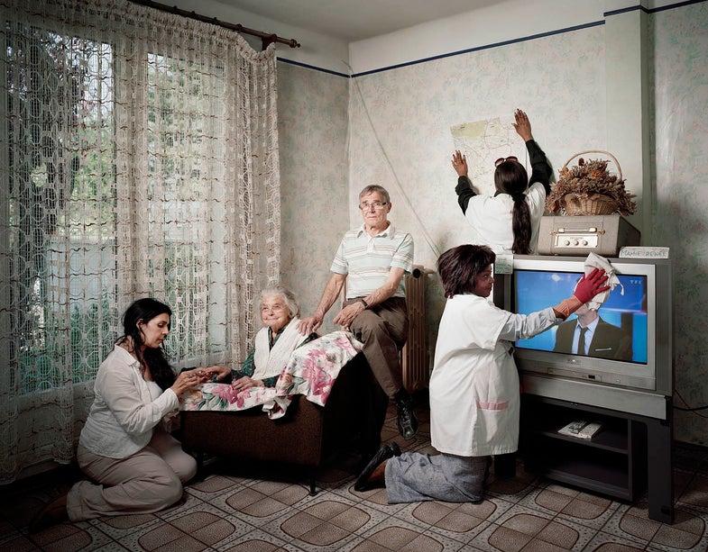 France, Villejuif, 26 April 2011 Portrait of Renée Devillière (in the middle), 100 years old, with Alzheimer, in her home. From left to right : Malika Berkane (medical psychological assistant), Fernand Devillière (her son), Marie-Thérèse Kanu-Lusova (care assistant), Josiane Masika-Sango (care assistant). France, Villejuif, 26 avril 2011 Portrait de Renée Devillière (au centre), 100 ans, atteinte de la maladie d’Alzheimer, chez elle. Avec, de gauche à droite: Malika Berkane (aide médico-psychologique), Fernand Devillière (son fils), Marie-Thérèse Kanu-Lusova (auxiliaire de vie), Josiane Masika-Sango (auxiliaire de vie). Jean-Robert Dantou / Agence VU