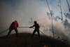Firefighters attempt to extinguish a blaze burning in Alvaiazere, Portugal. Rafael Marchante is a Portugal-based Reuters staffer.
