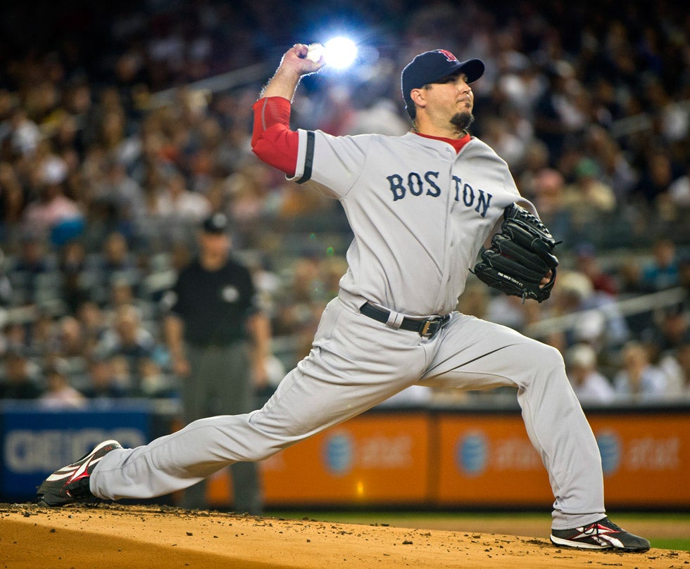 A fan's camera flash goes off in the stands as Boston Red Sox starting pitcher Josh Beckett throws a pitch to the New York Yankees in the first inning of a game at Yankee Stadium. Ray Stubblebine is New York-based Reuters staffer who has been with the agency since 1988. See more of his work on his <a href="http://raystubblebine.com/Welcome.html">personal site</a>.