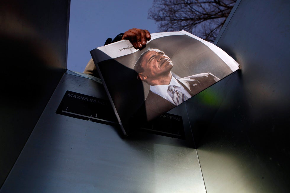 A woman sells newspapers with a picture of U.S. President Barack Obama on the National Mall during last Monday's inaugural events. Eric Thayer is a Los Angeles-based photojournalist who, in addition to Reuters, shoots for the likes of <em>The New York Times</em>, Getty and the <em>Wall Street Journal</em>. See more of his work on his <a href="http://www.ericthayer.com/">personal site</a>.