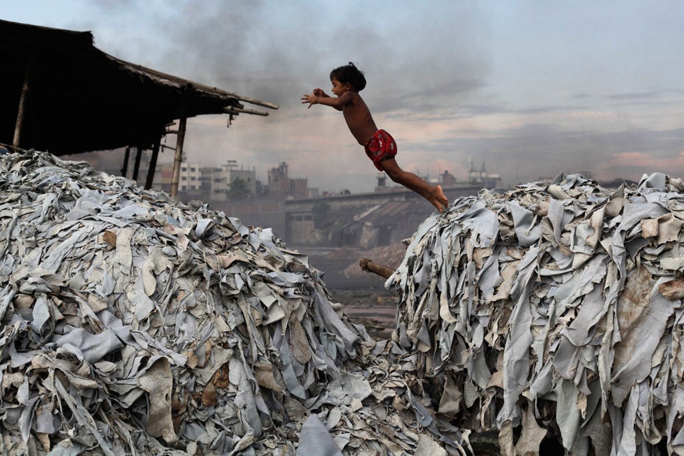 A child jumps on the waste products that are used to make poultry feed as she plays in a tannery at Hazaribagh in Dhaka, Bangladesh. Andrew Biraj is a Reuters staff photographer based out of Dhaka, Bangladesh and the winner of a 2011 World Press Photo award. Check out his image from last week's gallery <a href="http://www.americanphotomag.com/photo-gallery/2012/10/photojournalism-week-october-5-2012?page=7">here</a>.