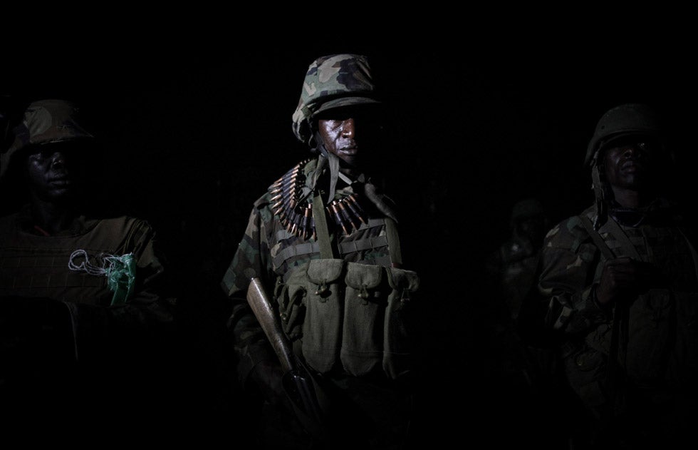 Ugandan troops serving with the African Union Mission in Somalia (AMISOM) line up in the middle of the night ahead of a ground advance as part of a joint Somali National Army (SNA) and AMISOM operation in an area south-west of the Somali capital Mogadishu.