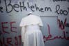 Pope Francis prays at Israel's separation barrier on his way to a mass in Manger Square next to the Church of the Nativity, traditionally believed to be the birthplace of Jesus Christ in the West Bank city of Bethlehem on Sunday, May 25, 2014. Francis called the Israeli-Palestinian stalemate "unacceptable" as he landed Sunday in the West Bank town of Bethlehem in a symbolic nod to Palestinian aspirations for their own state. Ariel Schalit is an AP staffer based in Israel. See more work <a href="http://www.americanphotomag.com/photo-gallery/2014/02/best-photojournalism-month-january-2014?page=9">here</a>.