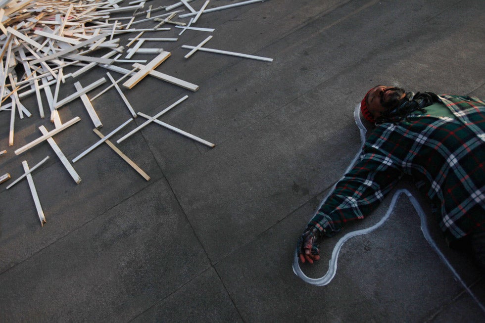 An activist lies on the floor during a protest against the government of Mexico's President Felipe Calderon, in power for six years, at the Estela de Luz monument in Mexico City. Edgard Garrido, who has been with Reuters since 2007, is also an accomplished string muscician. See more of his work <a href="http://blogs.reuters.com/edgardgarrido/">here</a>.