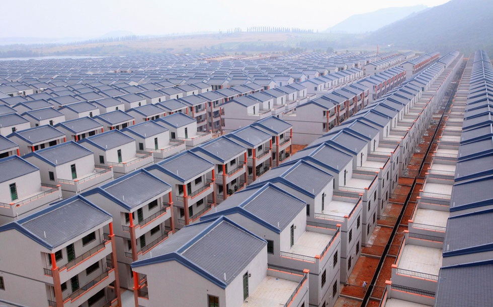 Newly-built houses stand in rows in the village of Dadun in Hainan province, China.