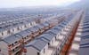 Newly-built houses stand in rows in the village of Dadun in Hainan province, China.