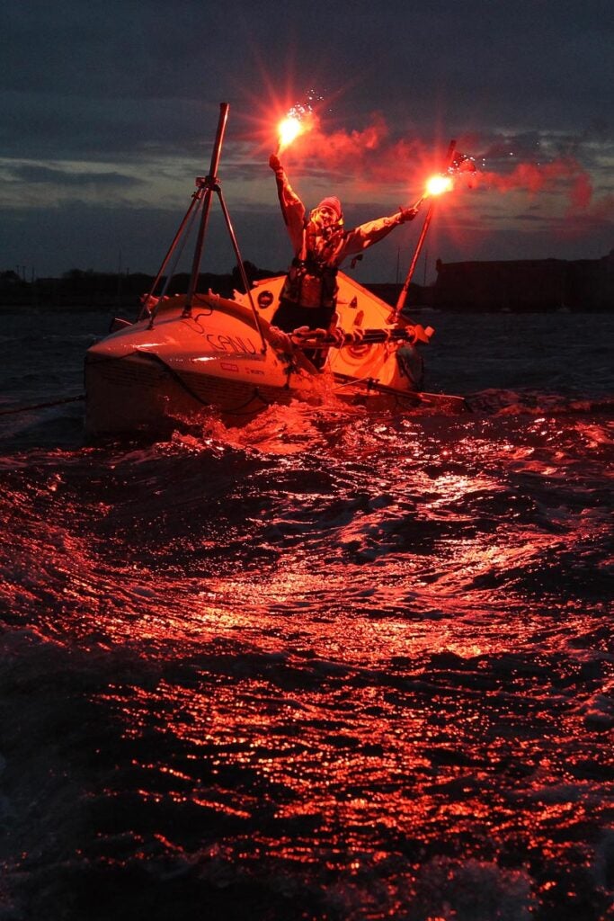 Quebec rower Mylene Paquette celebrates as she arrives in Lorient, western France, Tuesday, Nov. 12, 2013, after a solo journey across the Atlantic Ocean. Paquette is the first North American woman to row solo across the North Atlantic. She left Halifax just over four months ago in a specially designed 7.3-metre boat propelled only by Paquette and the currents. David Vincent is a stringer working for the Associated Press in France.