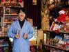 man in lab coat holding vials of candy