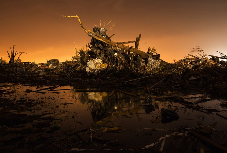 A car rests on top of a pile of debris pushed up by the wind in an area heavily damaged by the May 20 afternoon tornado in Moore, Oklahoma May 27, 2013. The tornado was the strongest in the United States in nearly two years and cut a path of destruction 17 miles (27 km) long and 1.3 (2 km) miles wide. REUTERS/Lucas Jackson (UNITED STATES - Tags: DISASTER ENVIRONMENT TRANSPORT) - RTX102M3