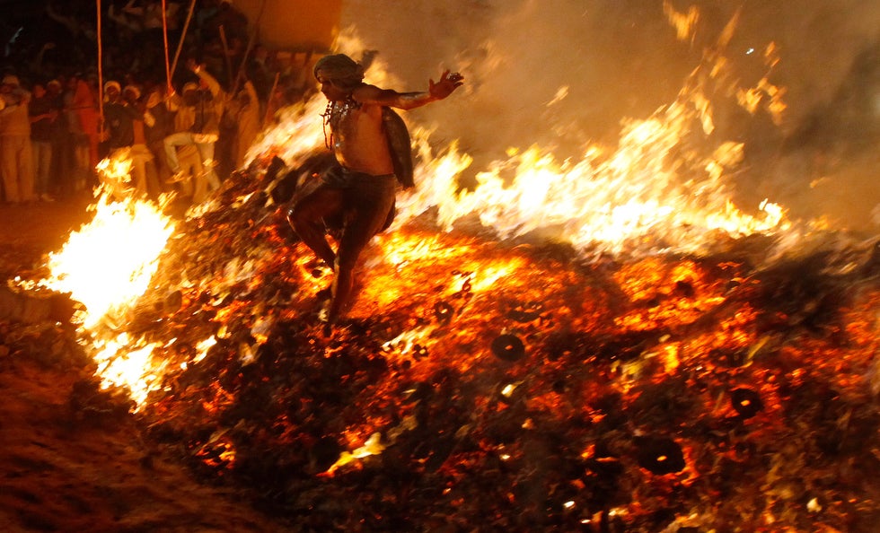 Taken during the first day of the Hindu Holi festival celebrating the coming spring, Reuters photographer Adnan Abidi captured this image of a Hindu priest jumping out of a ceremonial fire. The fire is symbolic of the victory of good over evil. Abidi has been with Reuters for seven years and shoots primarily in the New Delhi region of India.