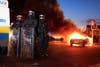Police officers in riot gear stand near a burning hijacked car during rioting in East Belfast. Violent protests continue in Northern Ireland as loyalists renewed their anger against restrictions on flying the union flag from Belfast City Hall. Cathal McNaughton is an Irish-based photographer working for Reuters. Before working with Reuters he started his career with the Irish News in Belfast. See more of his work on his <a href="http://cathalmcnaughton.com/">site</a>. Also check out his image from last week's round-up <a href="http://www.americanphotomag.com/photo-gallery/2013/01/photojournalism-week-january-11-2013?page=2">here</a>.