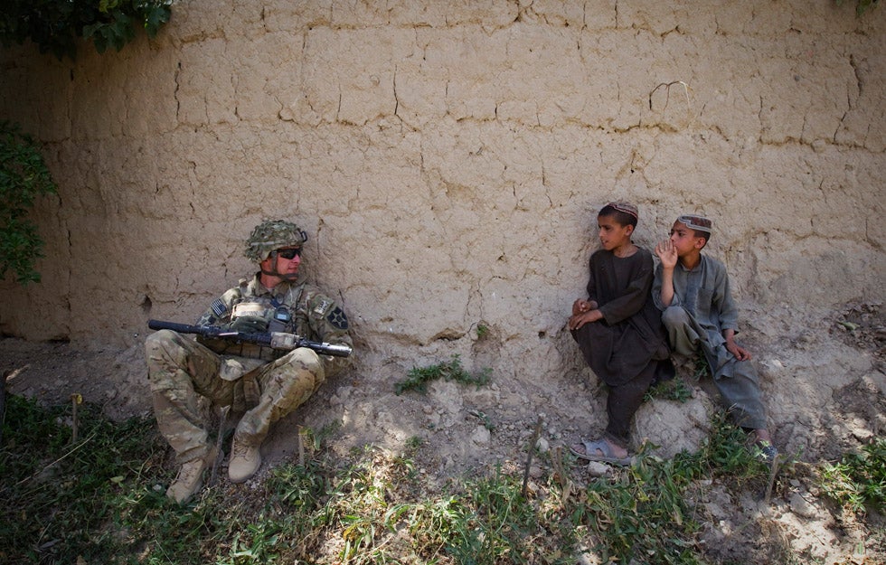 Afghan boys look at a U.S. Army soldier in Zharay district of Kandahar province in Afghanistan. Shamil Zhumatov is a Reuters staffer currently covering the ongoing conflict and US troop withdrawal in Afghanistan.