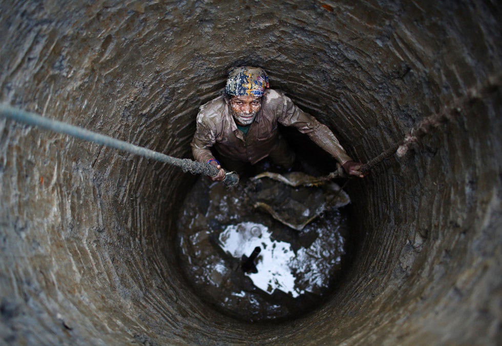 A man looks up at his friends while constructing a well in Lalitpur, Nepal. Navesh Chitrakar is a Reuters staffer based in Nepal. You can see more of his incredible work in our past round-ups <a href="http://www.americanphotomag.com/photo-gallery/2013/04/photojournalism-week-april-12-2013">here</a>.