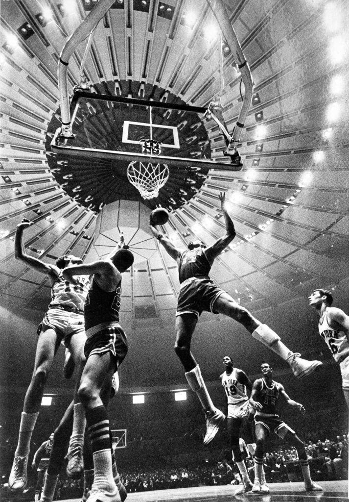 Wilt Chamberlin of the 76ers going up for a layup during a Knicks game at Madison Square Garden, seen in the back ground #19 Willis Reed of the Knicks, 1968