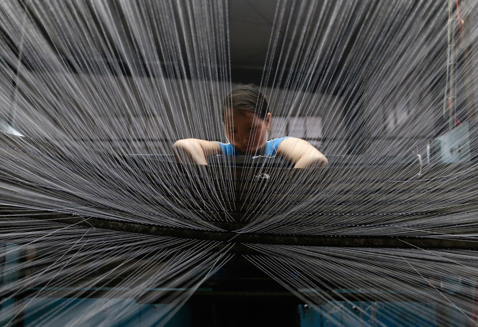An employee works inside a textile factory in Linhai, Zhejiang province, China. William Hong is a Reuters photojournalist working in China. See more of his work <a href="http://www.americanphotomag.com/photo-gallery/2013/04/photojournalism-week-april-12-2013?page=2">here</a>.