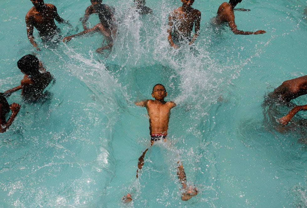 A boy jumps into a swimming pool to cool himself on a hot day in the southern Indian city of Chennai. Babu Babu is a Reuters photographer based in Chennai. See more of his outstanding work in our previous round-ups <a href="http://www.americanphotomag.com/photo-gallery/2013/03/photojournalism-week-march-29-2013?page=1">here</a> and <a href="http://www.americanphotomag.com/photo-gallery/2013/02/photojournalism-week-february-1-2013?page=8">here</a>.