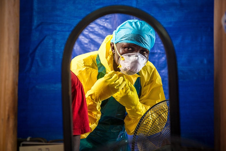 A healthcare worker dons protective gear before entering into an Ebola treatment centre in the west of Freetown, Sierra Leone, Thursday, Oct. 16, 2014. The deadly Ebola virus has infected two people in what was the last untouched district in Sierra Leone, the government said Thursday, a setback in efforts to stop the spread of the disease in one of the hardest-hit countries. (AP Photo/Michael Duff)