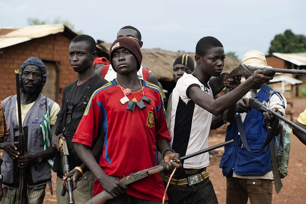 Men claiming to be anti-Balaka fighters, opposed to the Seleka, are seen posing with their weapons in the main street of Njoh, Central African Republic, September 24, 2013.