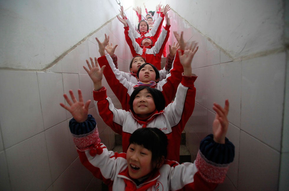 Students exercise during class break in a classroom building on a foggy day in Jinan, Shandong province, China.