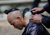 An ethnic Miao minority man shaves another villager's head with a sickle in the village of Basha in Congjiang county, Guizhou province, China. Jason Lee is a Reuters staffer based in Eastern China. See more of his work, including this great shot of a panda playing the piano, <a href="http://www.americanphotomag.com/photo-gallery/2013/03/photojournalism-week-march-1-2013?page=4">here</a>.