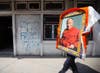 A Tibetan man walks down the street carrying a portrait of the Dalai Lama in Kathmandu, Nepal. Navesh Chitrakar is a Reuters staff photographer based in Nepal. You can see a fantastic portfolio of his work from the region on the <a href="http://in.reuters.com/news/pictures/slideshow?articleId=INRTR2TSMC#a=1">Reuters site</a>.