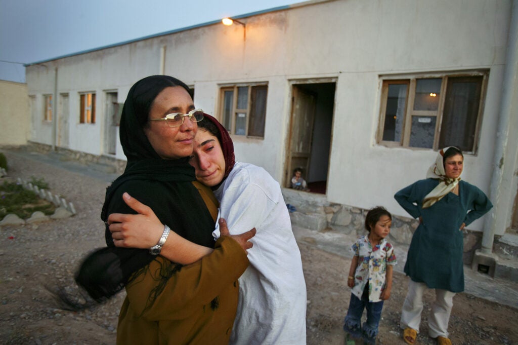 Mejgon, 16, weeps in the arms of her caseworker near fellow residents at an NGO shelter run by Afghan women in Herat, Afghanistan. Mejgonís father sold her at the age of 11 to a 60-year-old man for two boxes of heroin.