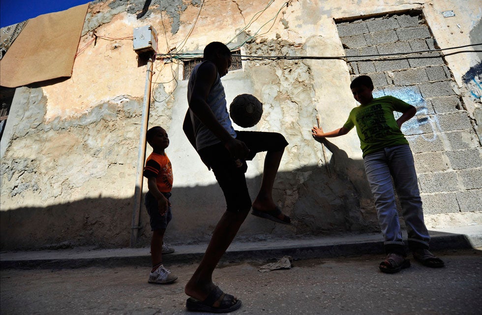 Boys juggle a football in front of their house in Benghazi, Libya. Esam Al-Fetori is a fulltime photographer based in Libya and shooting for Reuters.