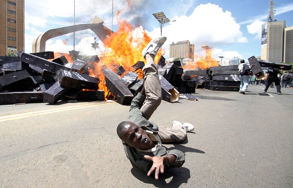 An activist reacts as mock coffins burn outside the Kenyan parliament during a protest dubbed "State Burial-Ballot Revolution", a demonstration against legislators' plans to receive higher bonuses. Thomas Mukoya has been a photographer with Reuters since 2002. He is also the President of the Photojournalists' Association of Kenya. Check out more of his work <a href="http://photojournalistskenya.com/new/index.php?option=com_k2&amp;view=itemlist&amp;task=user&amp;id=66:thomasmukoya">here</a>.