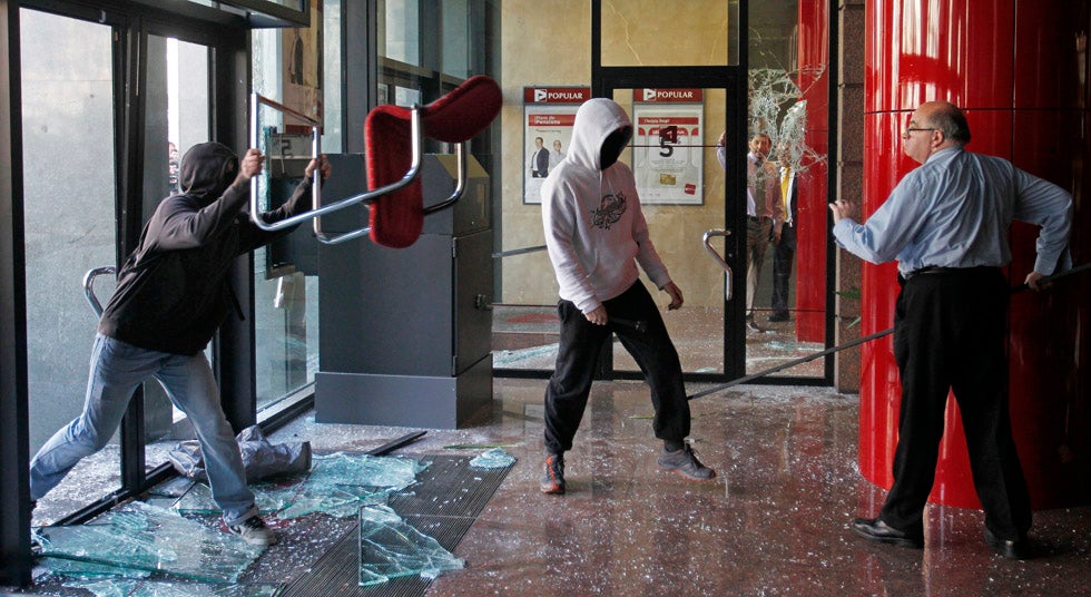 This image of a man confronting hooded protestors as they vandalized a Barcelona bank was captured by Barcelona-based Reuters photographer Albert Gea.