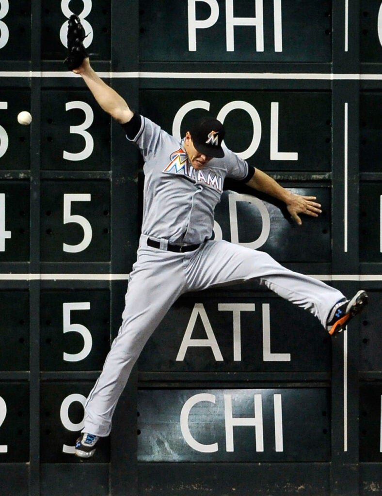 Miami Marlins left fielder Logan Morrison misses a catch deep in the outfield, giving the Houston Astros' Jordan Schafer a double in the fifth inning of the game. Pat Sullivan is an AP staff photographer based in Houston, Texas.