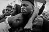 Men mourn the death of Freddie Gray in West Baltimore, a day after his funeral riots broke out. Gray died from spinal cord injury sustained while in police custody on April 12. String police shootings and brutality have a massive launched national protests and the "Black Lives Matter" protests.  Many question, maybe the race relations in America have not changed since the riots of 1960.