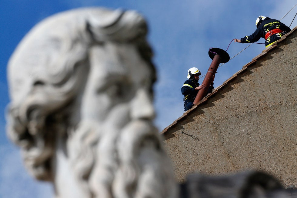 Workers install a chimney on the roof of the Sistine Chapel in the Vatican, which is used to announce to the world whether or not a new pope has been elected. If black smoke comes out of the chimney, no new pope, but if white smoke comes out, as it did Wednesday, a new pope has been decided upon. Alessandro Bianchi is an Italian-based photographer shooting for Reuters. See more of his work <a href="http://blogs.reuters.com/alessandrobianchi/">here</a>.