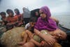 Rohingya Muslims, trying to cross the Naf River into Bangladesh to escape sectarian violence in Myanmar, look on from an intercepted boat. Despite growing calls for the border to be opened, Bangladeshi guards have turned back 16 boats carrying more than 660 Rohingya people, most of them women and children, since June 11. Munir Uz Zaman is a freelancer based in Bangladesh. Check out more of his work in our previous <a href="http://www.americanphotomag.com/photo-gallery/2012/04/photojournalism-week-april-20-2012?page=8">Photojournalism of the Week Gallery</a>.