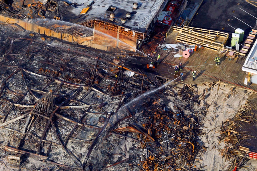 Aerial view of the devastation, including the charred remains of the Carousel Arcade, after a massive fire began yesterday near the Funtown Pier in Seaside Park and spread north, wiping out 4 blocks of boardwalk attractions into Seaside Heights. At right is the first of three trench cuts firefighters made in a desperate attempt to stop the advancing inferno. 9/13/2013 (Andrew Mills/The Star-Ledger)