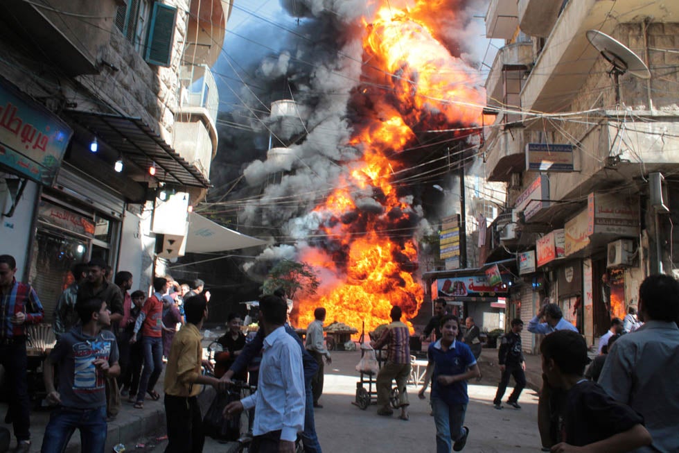 Residents run from a fire at a gasoline and oil shop in Aleppo's Bustan Al-Qasr neighborhood. Witnesses said the fire was caused by a bullet fired by a sniper loyal to Syrian President Bashar al-Assad at the Karaj al-Hajez crossing. Haleem Al-Halab is a stringer working for Reuters in Syria.