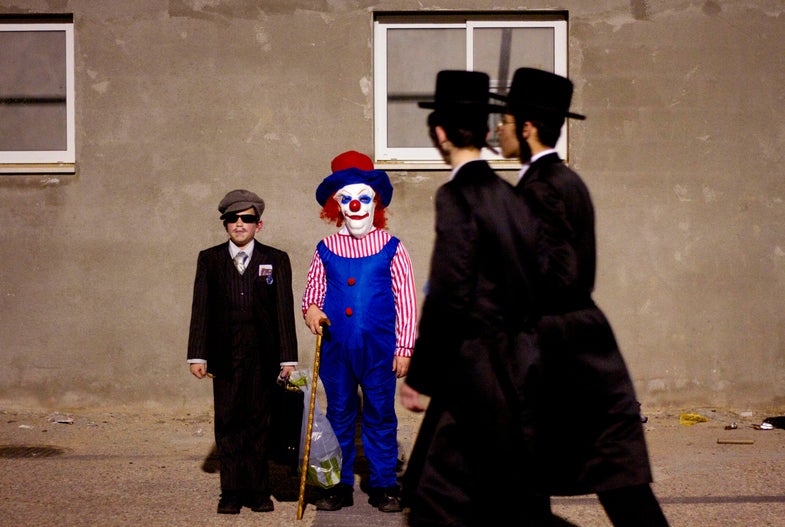 Ultra-Orthodox Jewish boys dressed for Purim pose for a photograph during celebration of Purim festival in Bnei Brak, near Tel Aviv, Israel, Wednesday, March 7, 2012. The Jewish holiday of Purim celebrates the Jews' salvation from genocide in ancient Persia, as recounted in the Scroll of Esther. (AP Photo/Ariel Schalit)