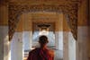 A novice monk on his way to collect offerings