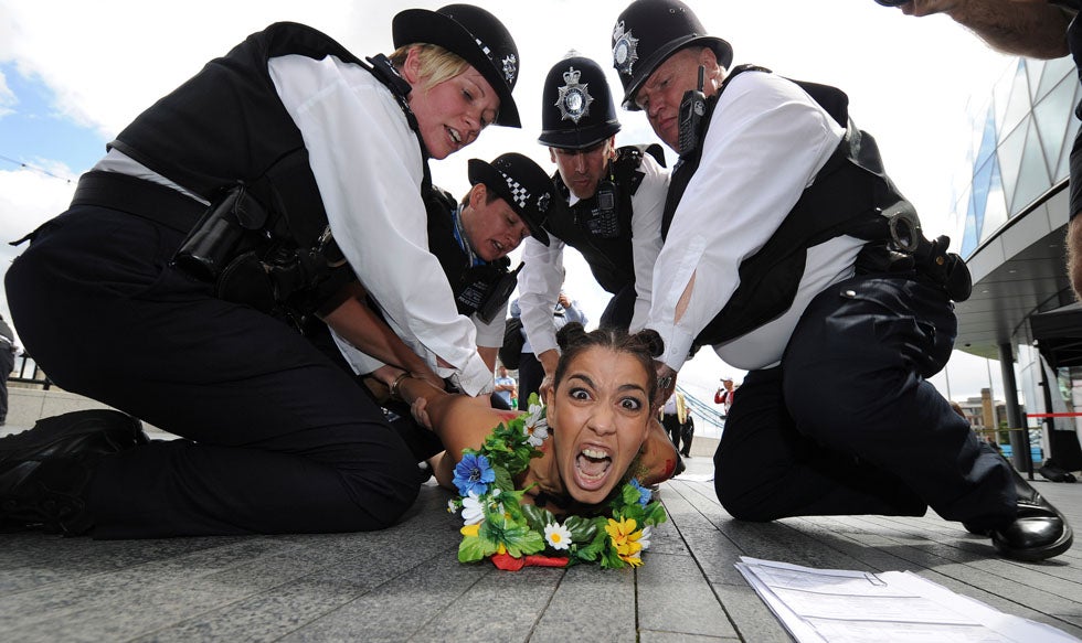 A Femen movement protestor is detained by police officers during a naked protest outside the 2012 Olympics Games. Paul Hackett is a British-based photojournalist covering the Olympic Games for Reuters. See more of his work on his <a href="http://paulhackett.net/">Website</a>.