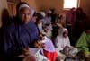 In this Monday, June 2, 2014 photo, Maimuna Abdullahi, left, writes down information from the blackboard as she and others attend school in Kaduna, Nigeria. Maimuna wore the scars of an abused woman anywhere: A swollen face, a starved body, and, barely a year after her wedding, a divorce. But for Maimuna, it all happened by the time she was 13. Maimuna is one of thousands of divorced girls in Nigeria who were married as children and then got thrown out by their husbands or simply fled. Sunday Alamba is based in Lagos, Nigeria. More of his work can be seen <a href="http://sundayalamba.com/">here. </a>