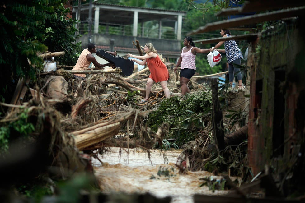 People evacuate with their belongings during flooding of the Capivari River in Xerem, in Duque de Caxias near Rio de Janeiro, Brazil. Ricardo Moraes is a full-time stringer working for Reuters in Rio de Janeiro. He started he career in photography at the age of 14 as a studio assistant. See more of his work <a href="http://www.americanphotomag.com/photo-gallery/2012/10/photojournalism-week-october-5-2012?page=2">here</a>.