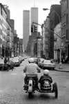"This was just a lucky shot looking down West Broadway around 1978-79 with the twin towers echoing the twin cyclists. I have no idea who the people are. Then as now, a sidecar in Manhattan was rare."