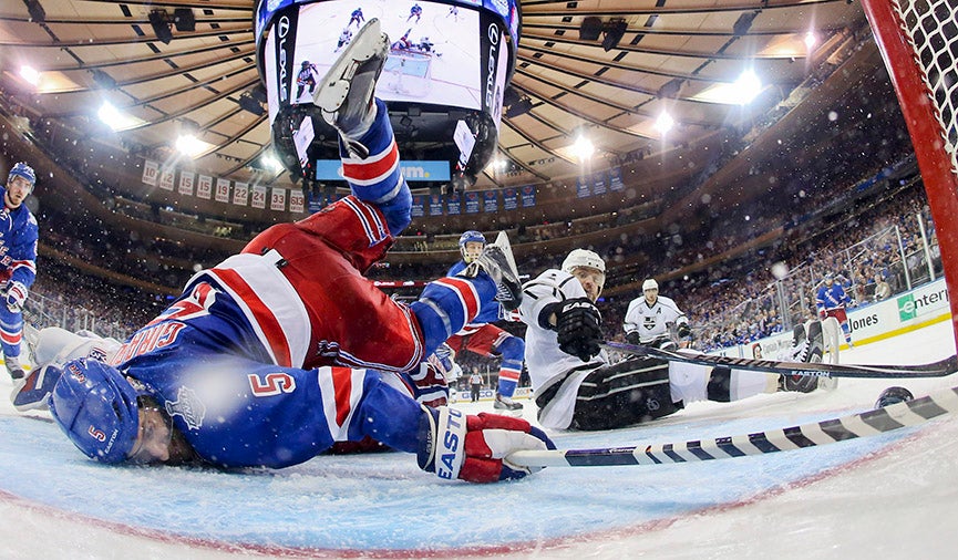 New York Rangers defenseman Dan Girardi (5) trips over goalie Henrik Lundqvist as he reaches to clear the puck from the goal line as Los Angeles Kings right wing Marian Gaborik tries to score in the third period during Game 3 of the NHL hockey Stanley Cup Final, Monday, June 9, 2014, in New York. The Kings won 3-0. Bruce Bennett has been photographing hockey since 1974. More of his work can be seen <a href="http://www.brucebennettstudios.com/">here. </a>