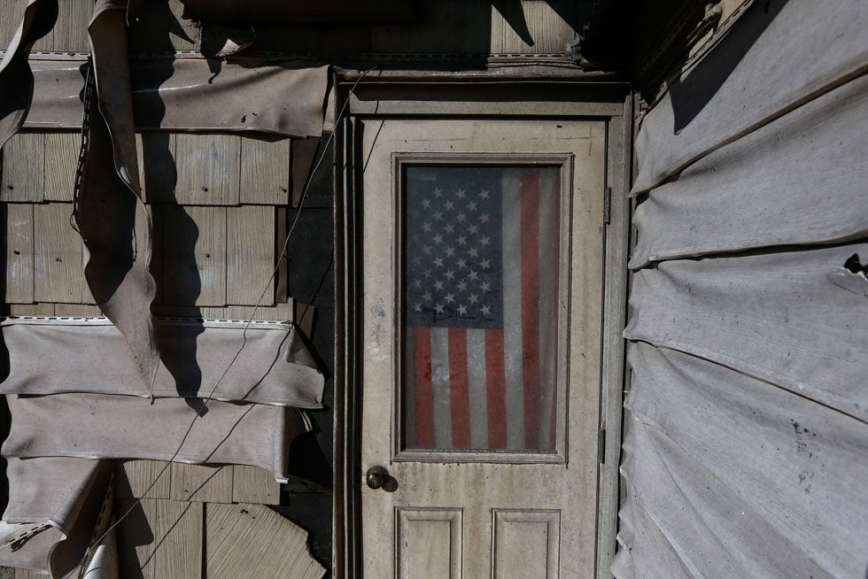 A U.S. flag is seen in the front door of a damaged home in the Breezy Point neighborhood which were left devastated by Hurricane Sandy in the New York borough of Queens. Adrees Latif was the 2008 Pulitzer Prize winner for Breaking News Photography. See more of his work in our <a href="http://www.americanphotomag.com/photo-gallery/2012/11/photojournalism-week-aftermath-sandy?page=4">past roundups</a>.
