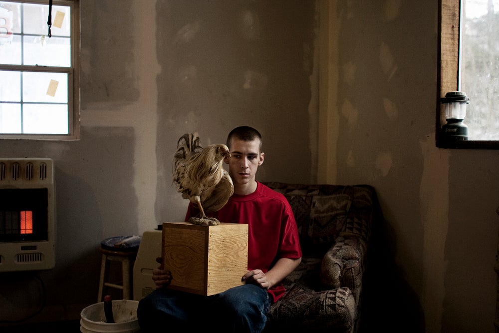 Tylor Woodrum, 16, holds a box containing his father's ashes on January 30, 2007 in Carbondale, Ohio. Dave Woodrum was killed in August of 2006 in a high-impact 4-wheeler accident. Dave's family had his body cremated and his favorite cock-fighting rooster mounted on top of the box.