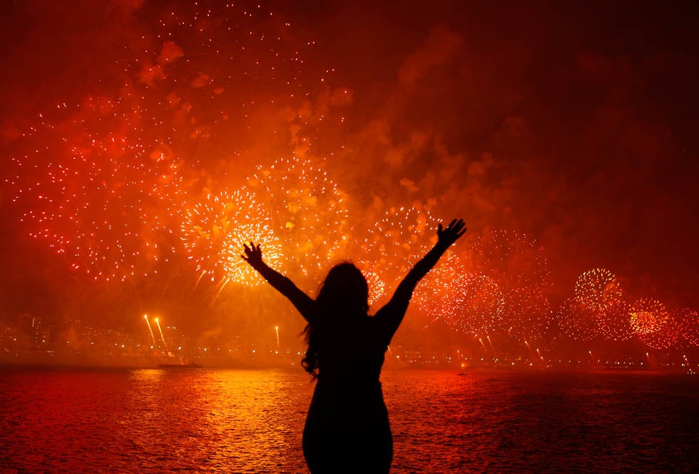 A woman celebrates the New Year as she watches fireworks exploding above Copacabana beach in Rio de Janeiro. Pilar Olivares is a Reuters staffer based in Brazil. See more of his work on his <a href="http://pilarolivares.photoshelter.com/">site</a>.