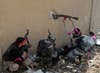 A Free Syrian Army fighter fires a rifle through a hole in a wall of a Syrian Army base, just before he was shot in the head by a sniper, during heavy fighting in the Arabeen neighborhood of Damascus. Goran Tomasevic is a Reuters staffer who predominantly covers wars and conflicts. See more of his incredible images from Syria <a href="http://www.americanphotomag.com/photo-gallery/2013/02/photojournalism-week-february-1-2013?page=6">here</a> and <a href="http://www.americanphotomag.com/photo-gallery/2013/01/photojournalism-week-january-25-2013?page=4">here</a>.