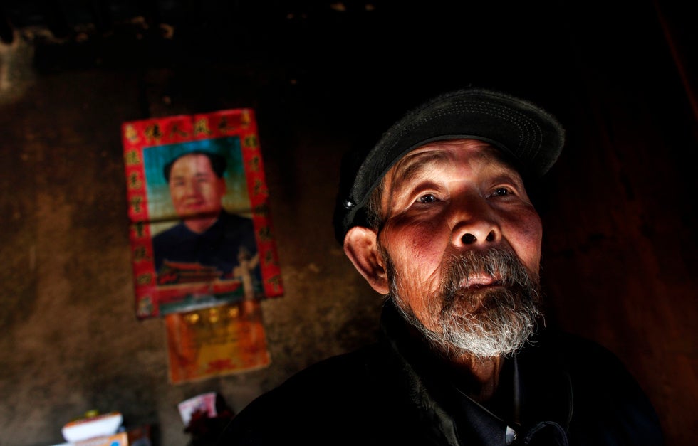 Ma Gang, 81, stands inside his house next to a portrait of former Chinese Chairman Mao Zedong in Yuangudui village. Barria is an Argentinean photographer who moved to China in 2010 to document daily life there for Reuters. See more of his work <a href="http://blogs.reuters.com/carlosbarria/">here</a>.