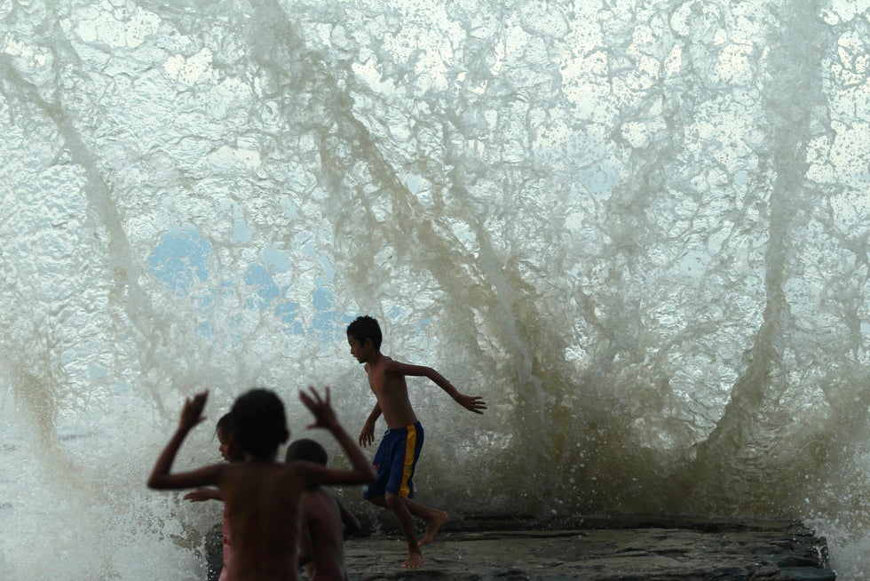 Eastern Timorese children run as water hits a seawall at Dili Beach on the tiny nation's north coast. Reuters photographer Beawiharta, who made this image, often updates his blog page on the Reuters' Website, you can keep up to date with his shooting adventures <a href="http://blogs.reuters.com/beawiharta/">here</a>.